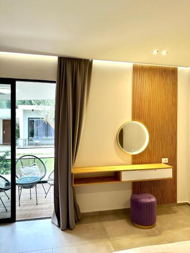 a dressing room with a mirror and a purple stool at Luna Mare Boutique Seaside in Borsh