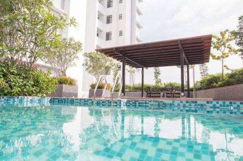 a swimming pool with a pergola next to a building at A0803 Platino walking ParadigmMall TVbox By STAY in Johor Bahru