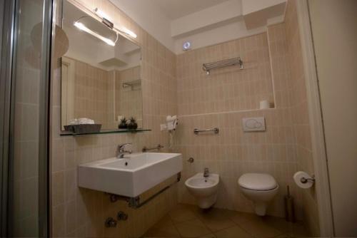 a bathroom with a sink and a toilet at Hotel Elite in Cervia