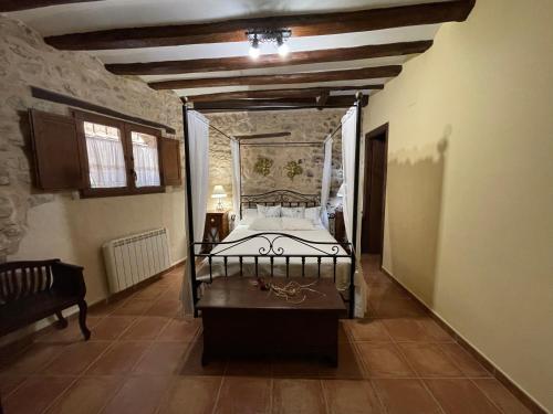 a bedroom with a large bed in a room at Casa Lidia - Antigua Posada Real in Valderrobres