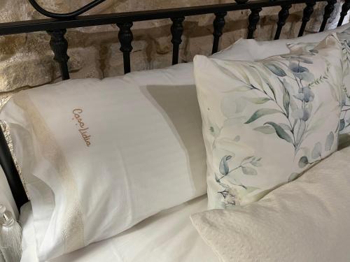 a bed with two white pillows on it at Casa Lidia - Antigua Posada Real in Valderrobres