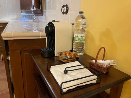 a kitchen counter with a bottle of water and a toaster at Casa Lidia - Antigua Posada Real in Valderrobres