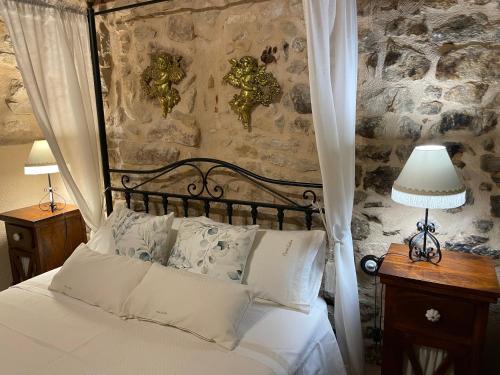 una camera da letto con un letto con cuscini bianchi di Casa Lidia - Antigua Posada Real a Valderrobres