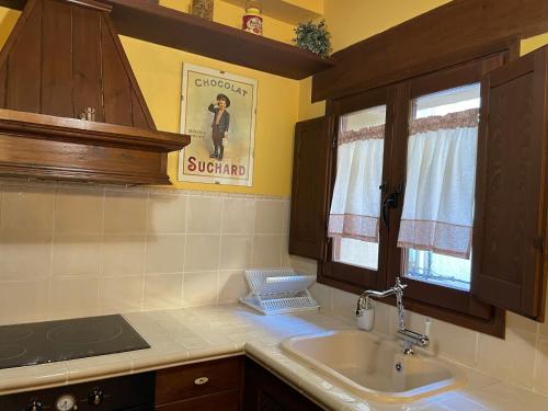 a kitchen with a sink and a window at Casa Lidia - Antigua Posada Real in Valderrobres