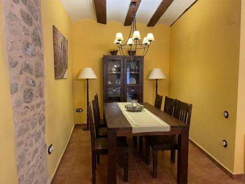 a dining room with a wooden table and chairs at Casa Lidia - Antigua Posada Real in Valderrobres