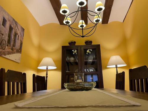 a dining room with a table and a chandelier at Casa Lidia - Antigua Posada Real in Valderrobres
