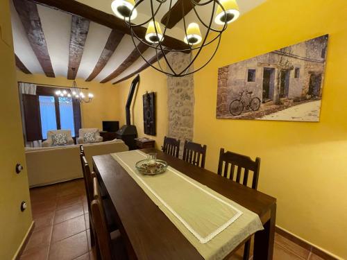 a dining room with a table and a chandelier at Casa Lidia - Antigua Posada Real in Valderrobres