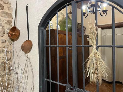 an iron door with a vase and a lamp at Casa Lidia - Antigua Posada Real in Valderrobres