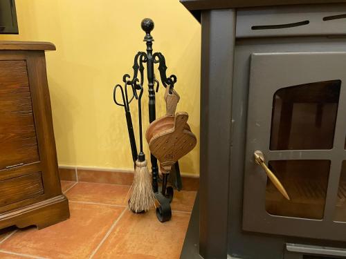 a broom on the floor next to an oven at Casa Lidia - Antigua Posada Real in Valderrobres