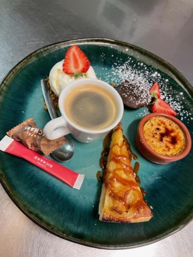 a green plate of food with a cup of coffee at Chambre indépendante Au Relais Normand in Cormeilles
