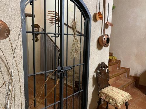 a door with a gate in a room with stairs at Casa Lidia - Antigua Posada Real in Valderrobres