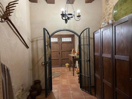 a hallway with an entry way with a chandelier at Casa Lidia - Antigua Posada Real in Valderrobres
