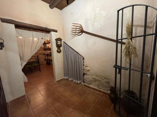 a hallway with a iron gate and a hand on the wall at Casa Lidia - Antigua Posada Real in Valderrobres