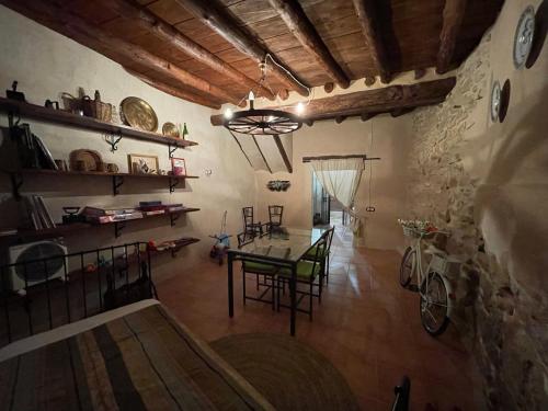 a room with a table and chairs in a building at Casa Lidia - Antigua Posada Real in Valderrobres