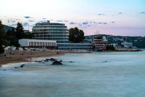 a view of a beach with a large building at SPA Hotel Sirius Beach - FREE SPA access in St. St. Constantine and Helena