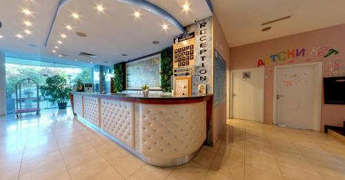 a restaurant with a bar in the middle of a room at SPA Hotel Sirius Beach - FREE SPA access in St. St. Constantine and Helena