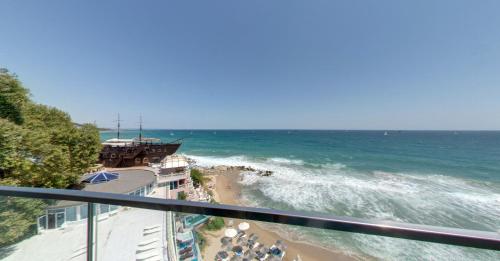 a view of the beach and ocean from a balcony at SPA Hotel Sirius Beach - FREE SPA access in St. St. Constantine and Helena