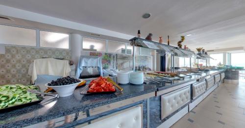 a large kitchen with a bunch of food on a counter at SPA Hotel Sirius Beach - FREE SPA access in St. St. Constantine and Helena