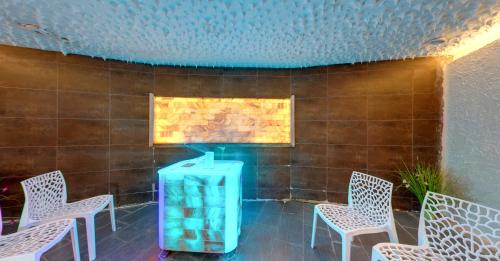 a group of chairs and a blue object in front of a wall at SPA Hotel Sirius Beach - FREE SPA access in St. St. Constantine and Helena