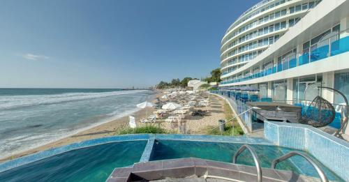 a resort with a swimming pool and a beach at SPA Hotel Sirius Beach - FREE SPA access in St. St. Constantine and Helena