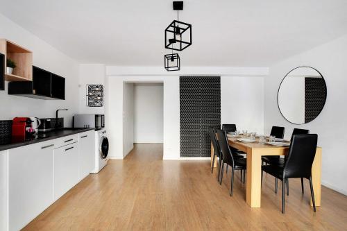 a kitchen and dining room with a table and chairs at Superb apartment in the heart of the 2nd arrond of Paris 8P3B in Paris