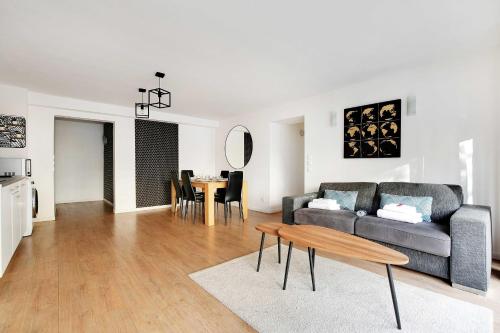 a living room with a couch and a table at Superb apartment in the heart of the 2nd arrond of Paris 8P3B in Paris