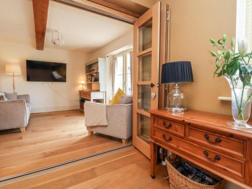 a living room with a table and a mirror at Garreg Wen in Holywell