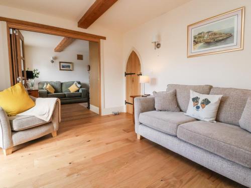 a living room with a couch and a chair at Garreg Wen in Holywell