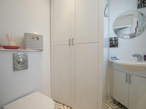 a white bathroom with a toilet and a sink at Gorgeous House near Windsor & River Thames in Datchet