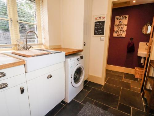 a laundry room with a washer and dryer at Garreg Wen in Holywell