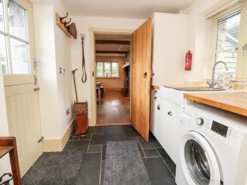 a laundry room with a washer and dryer at Garreg Wen in Holywell