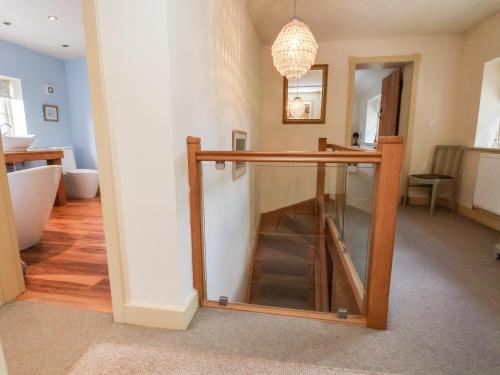 a room with a bathroom with a sink and a mirror at Garreg Wen in Holywell