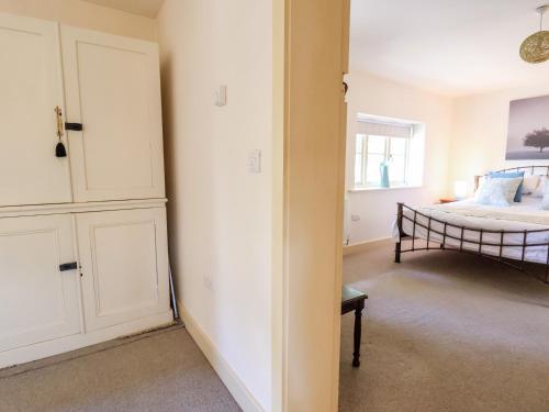 a bedroom with a bed and a window and a door at Garreg Wen in Holywell