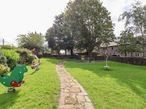 a park with children playing in the grass at Garreg Wen in Holywell