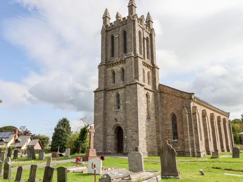 an old church with a tower in a cemetery at Garreg Wen in Holywell