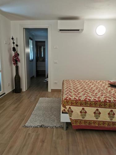 a white room with a bed and a rug at Casa Sant'Anna in Levanto
