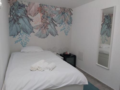 a bedroom with a bed with two towels on it at Comfort Rooms Remiza - Free Private Parking - Self check-in in Zagreb