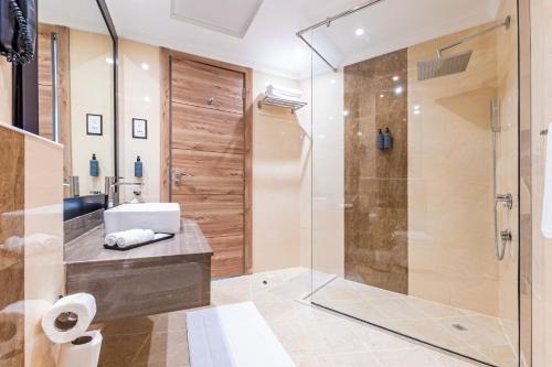 a bathroom with a shower and a sink at Pyramisa Hotel Apartments in Dubai