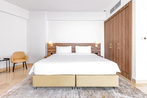 a bedroom with a large bed and a desk at Pyramisa Hotel Apartments in Dubai