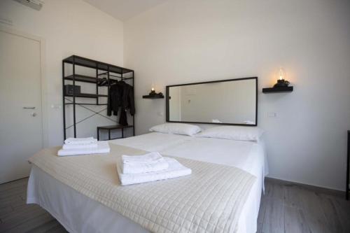a bedroom with two beds with towels on them at Hotel Elite in Cervia