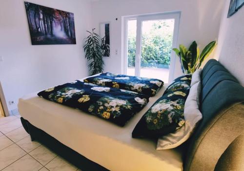 a couch with two pillows on it in a living room at Wohlfühloase in Birkenfeld