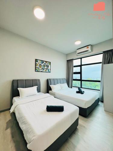 a hotel room with two beds and a window at Maison life 小居屋 Jesselton Quay CityPads in Kota Kinabalu