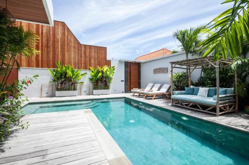 a swimming pool in the backyard of a house at Zayana Villas Resort Seminyak in Seminyak