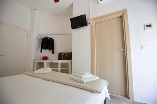 a white room with a bed and a sliding door at Hotel Elite in Cervia