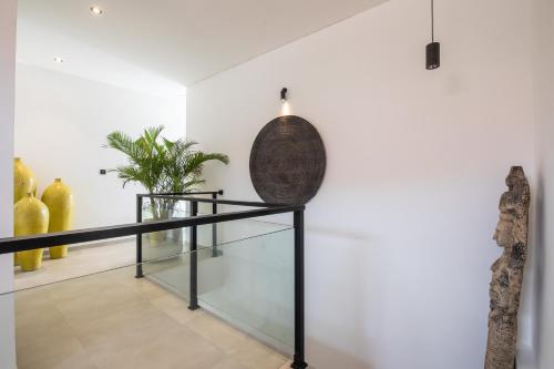a room with a glass shelf and a vase on the wall at Zayana Villas Resort Seminyak in Seminyak