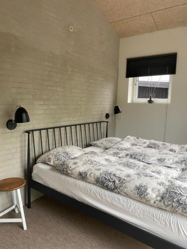 a bedroom with a bed and a window at Country Home in Hejnsvig