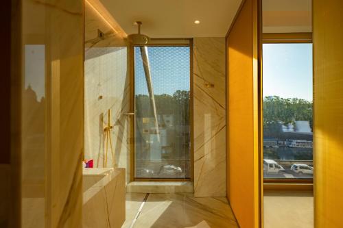 a bathroom with a sink and a large window at The First Musica in Rome