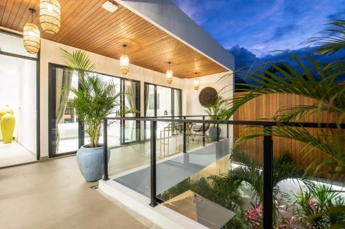 an indoor balcony of a house with plants at Zayana Villas Resort Seminyak in Seminyak