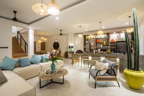 a living room with a couch and a table at Zayana Villas Resort Seminyak in Seminyak