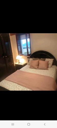a bedroom with a large bed with two pillows at Apartamento El Muro in Laredo